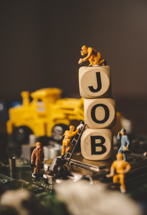 miniature people or small figure worker on wood block with the w