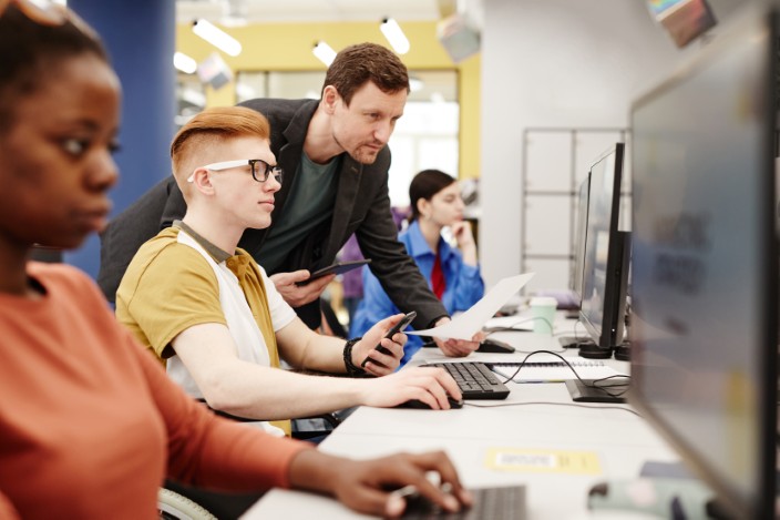 teacher with students in computer lab